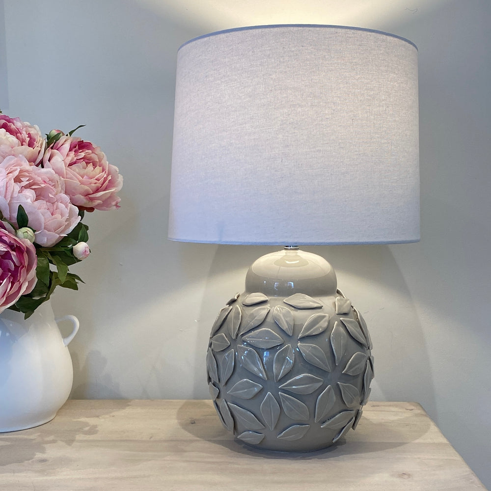 
                      
                        The Fleur Ceramic Grey Lamp & White Linen Shade
                      
                    